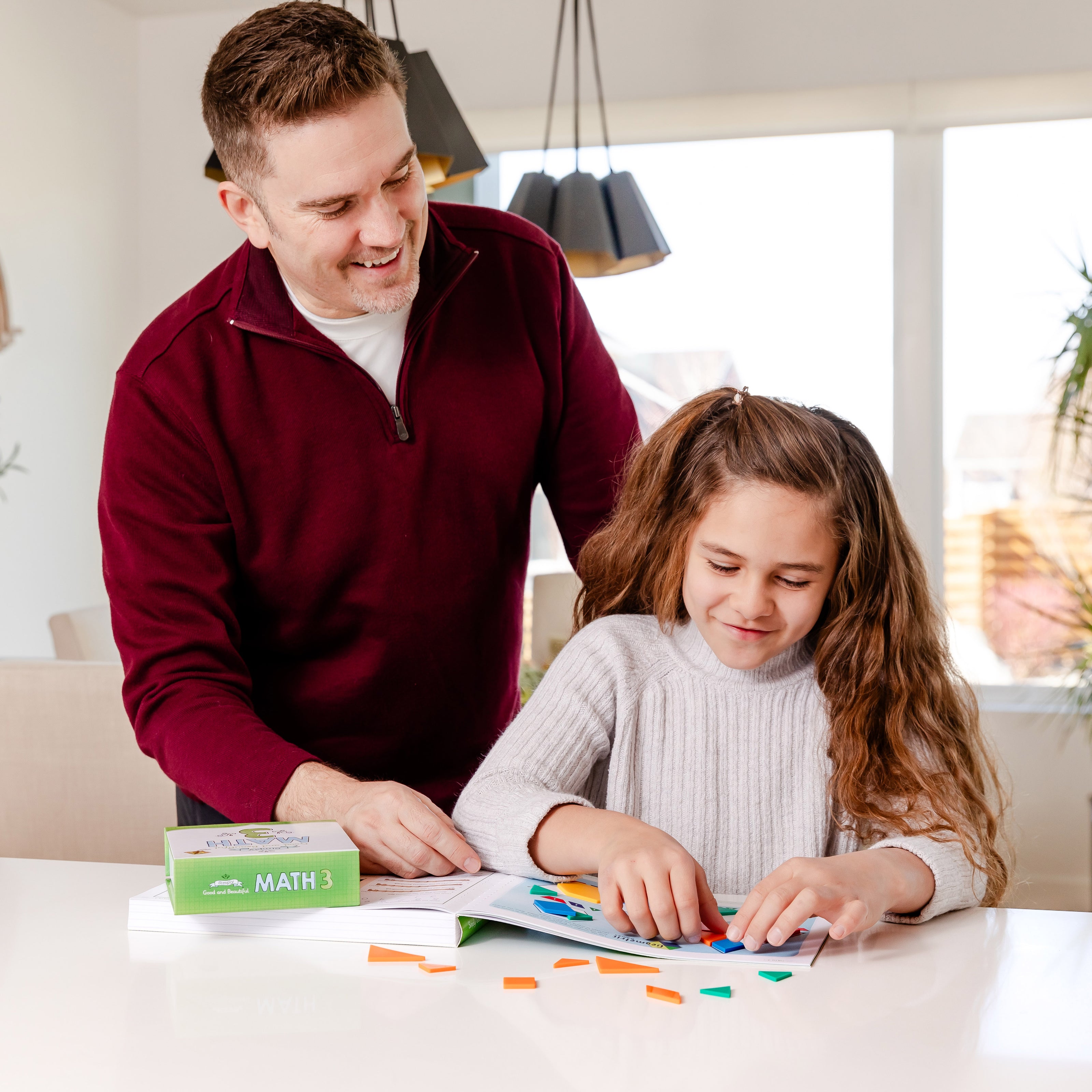 Father and daughter working on Simply Good and Beautiful Math 3 | The Good and the Beautiful