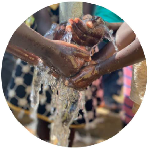 A photo of children's hands under a stream of water | The Good and the Beautiful