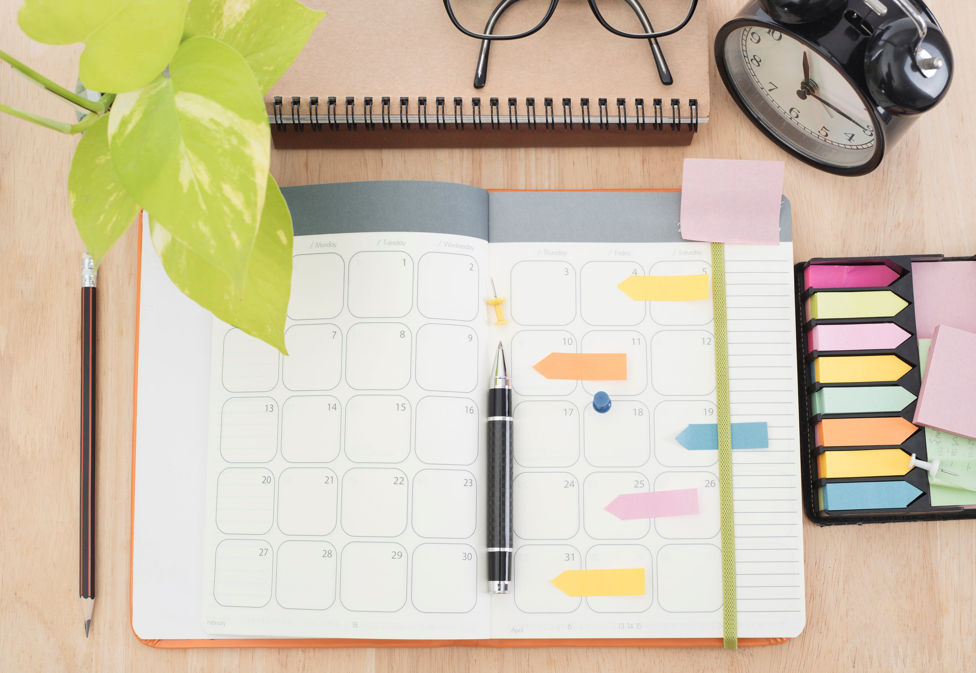 An open planner sitting on a desk | The Good and the Beautiful