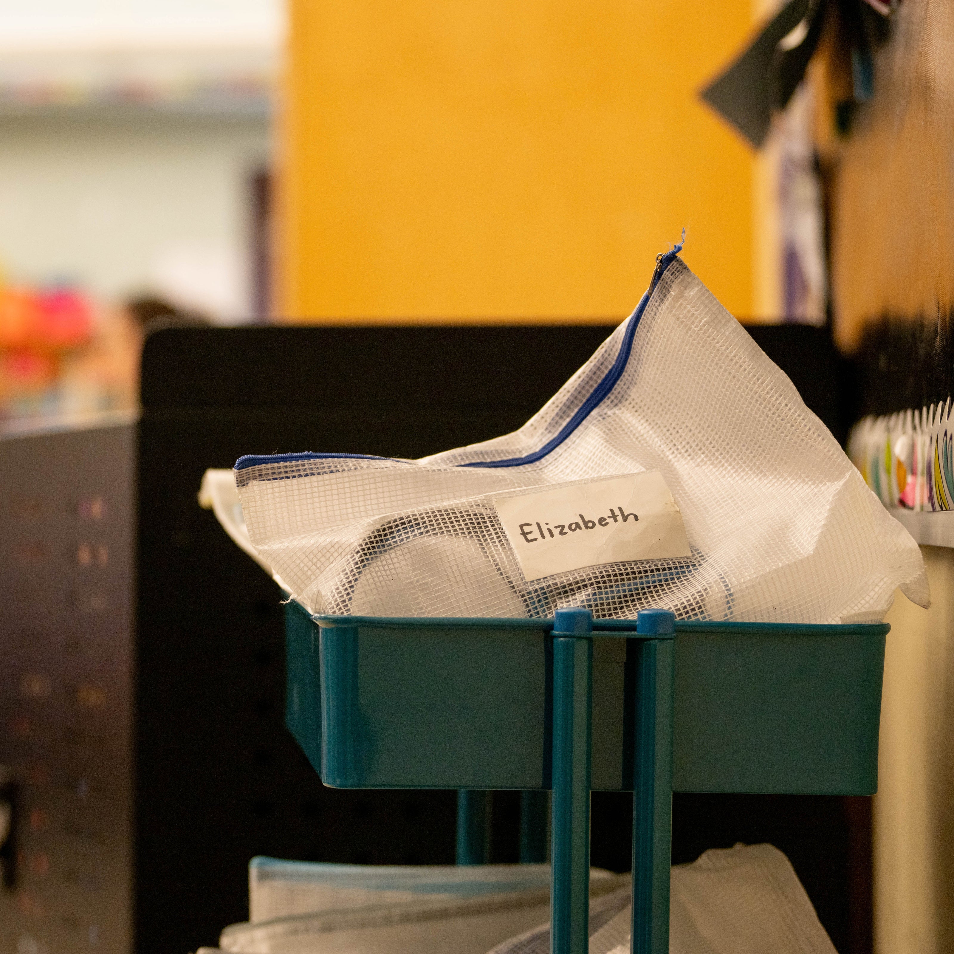 A cart with mesh bag showing a child's name on it | The Good and the Beautiful