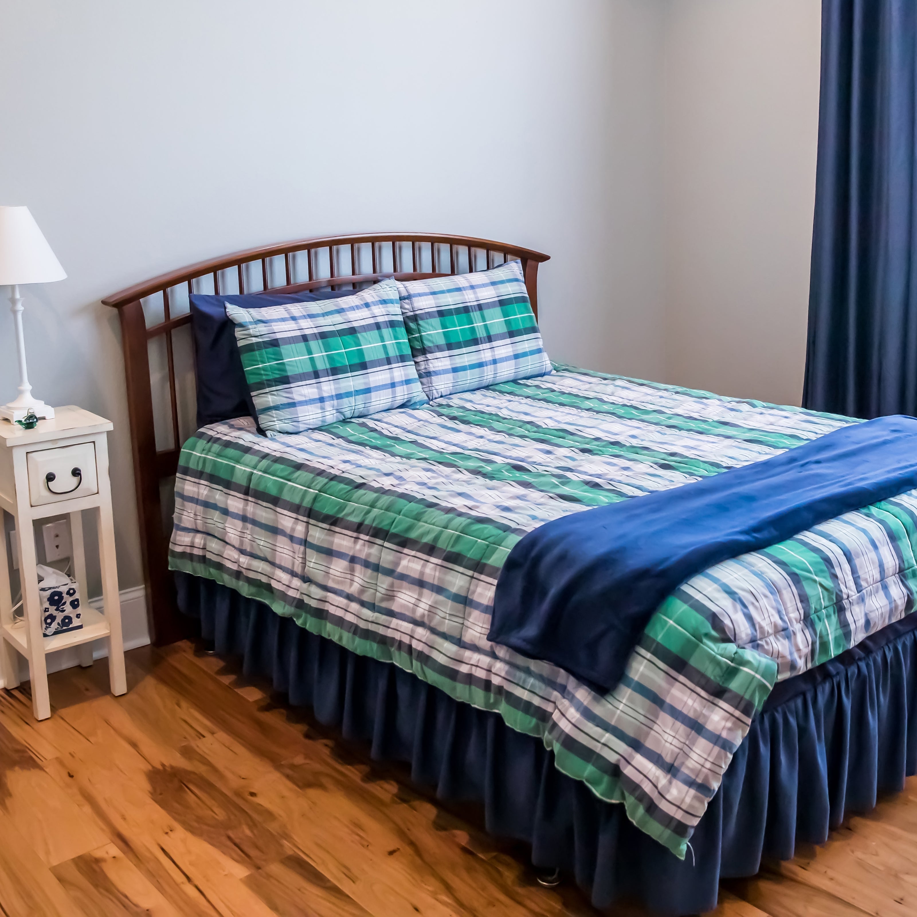 A child's room with a neatly made bed and nothing on the floor | The Good and the Beautiful