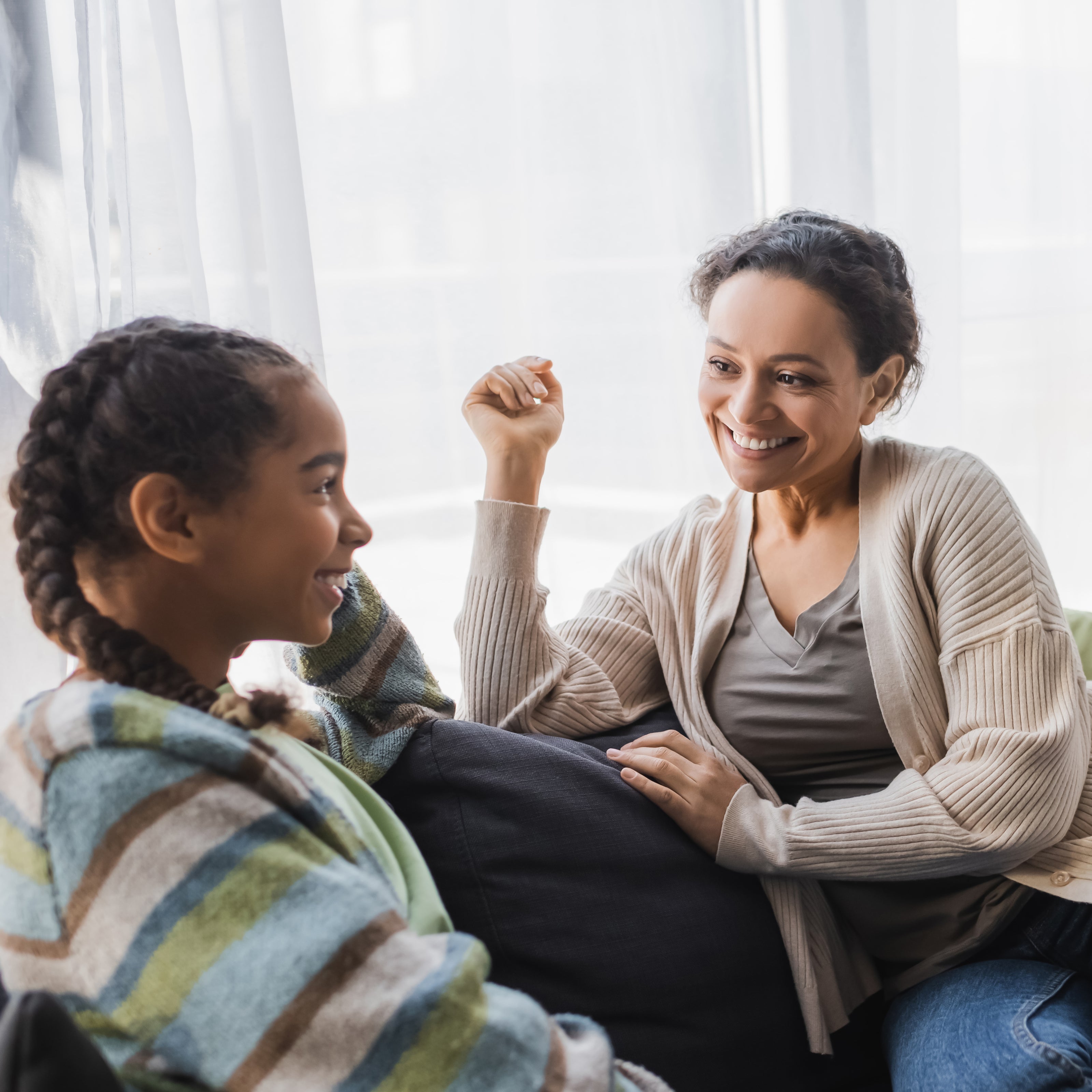 Mother and daughter talking together on couch | The Good and the Beautiful