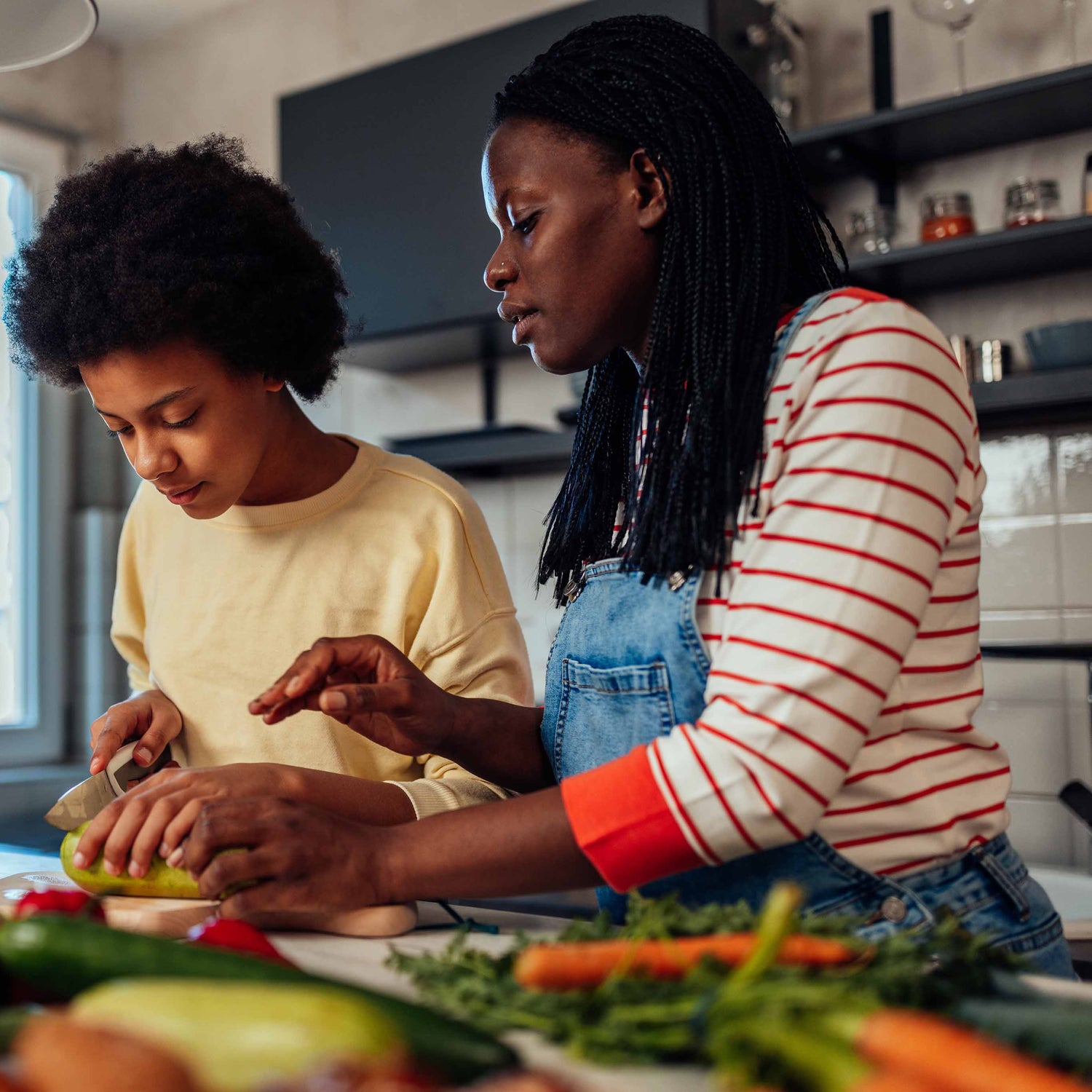 Mother and son preparing food in kitchen | The Good and the Beautiful