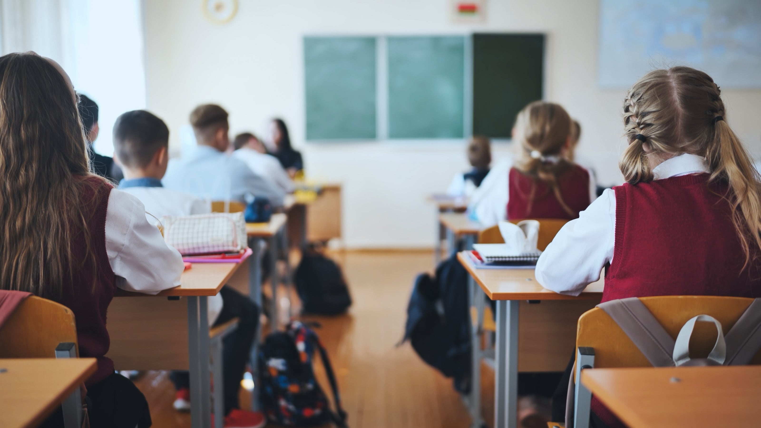 A view of a classroom with students sitting at desks | The Good and the Beautiful