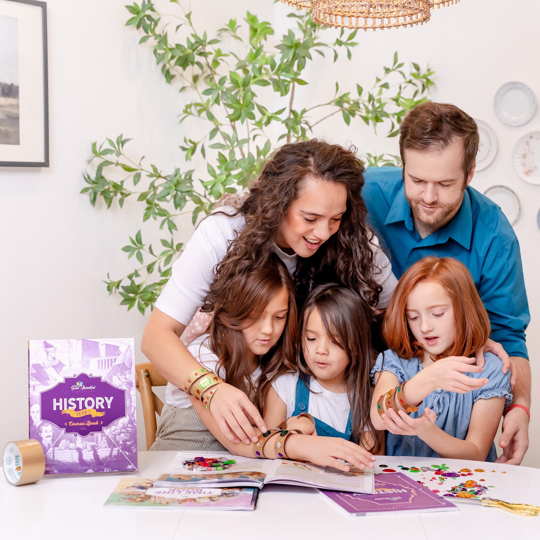 Three school-aged girls with their parents doing an activity from History Year 1 | The Good and the Beautiful