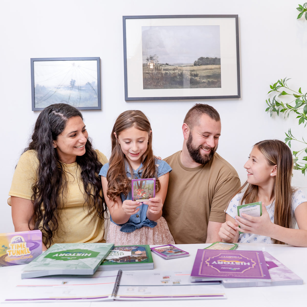 A family of four playing with the time tunnel cards from History year 1 | The Good and the Beautiful