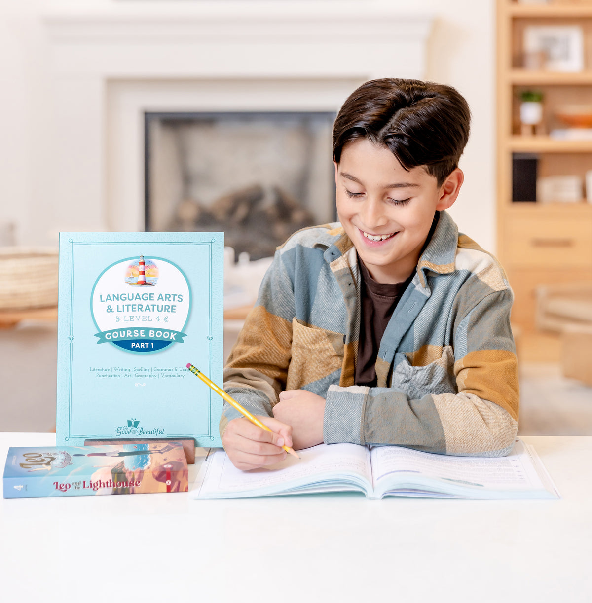 A school-aged boy writing in a course book with a pencil and the Language Arts level 4 course book displayed next to him | The Good and the Beautiful