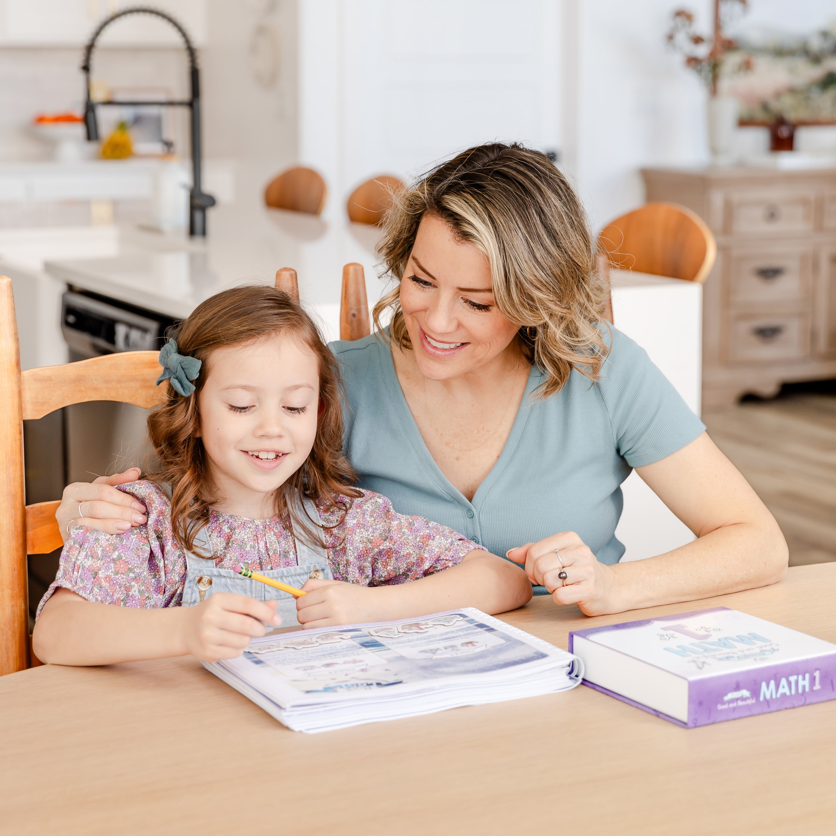 A school-aged girl working on Math 1 with her mother | The Good and the Beautiful