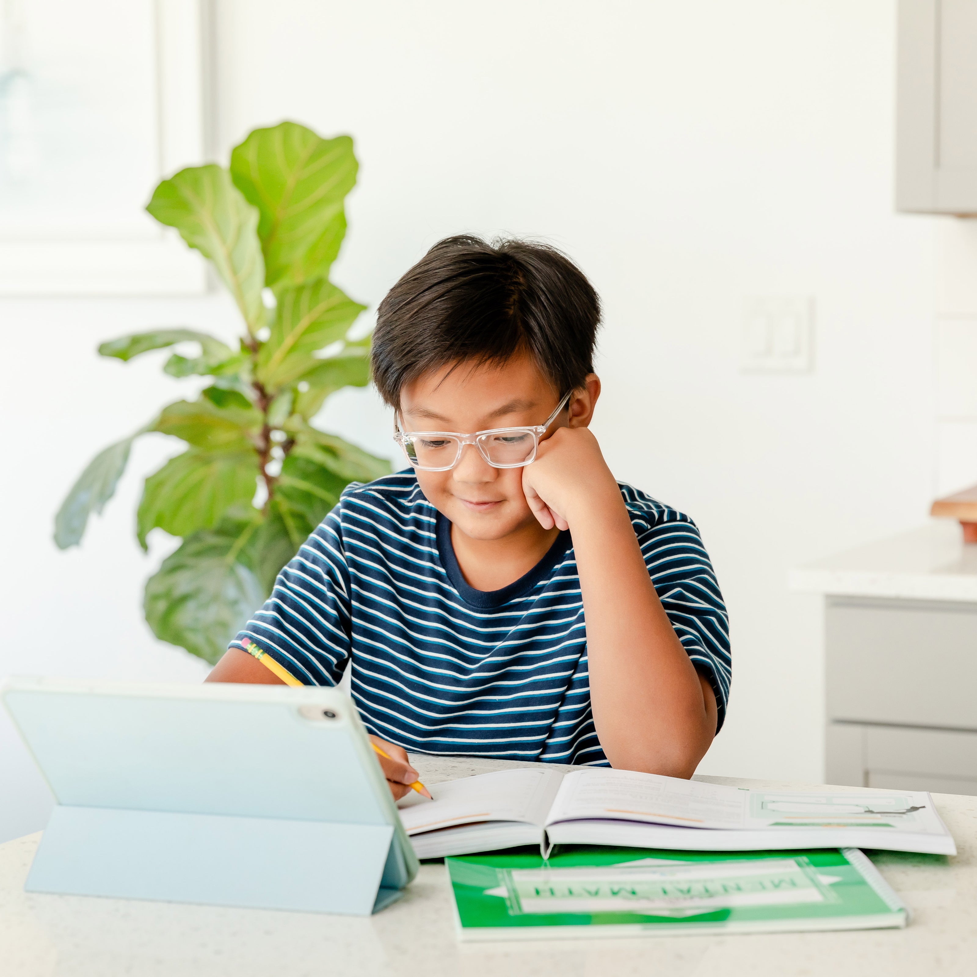 Young boy working on Simply Good and Beautiful Math Level 5 | The Good and the Beautiful 