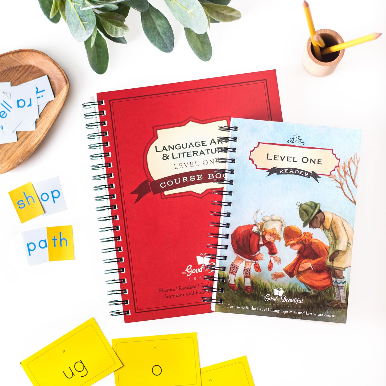 language arts homeschool curriculum for 1st grade includes course book, reader, and phonics cards