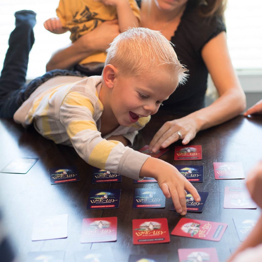 Photograph of Young Boy Playing Luke and Lily Card Game