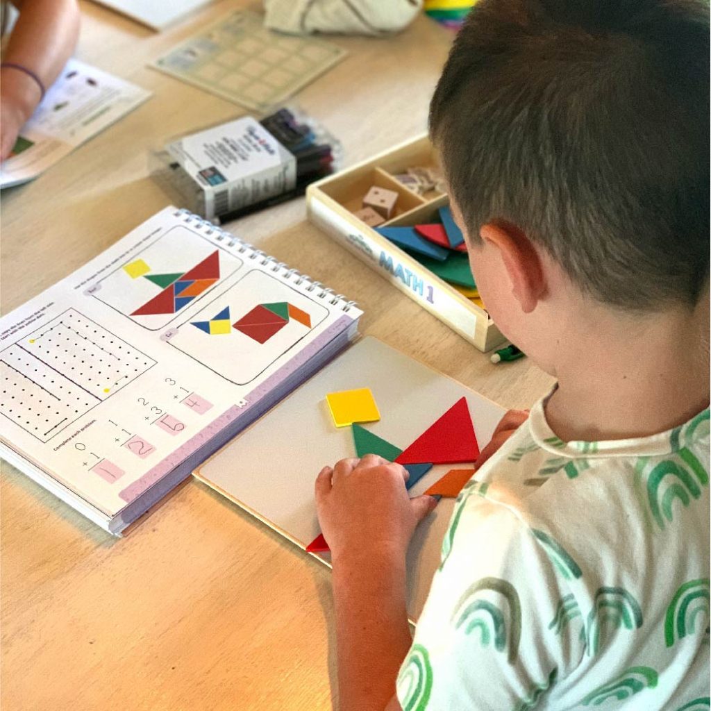 Photograph boy playing with tangrams