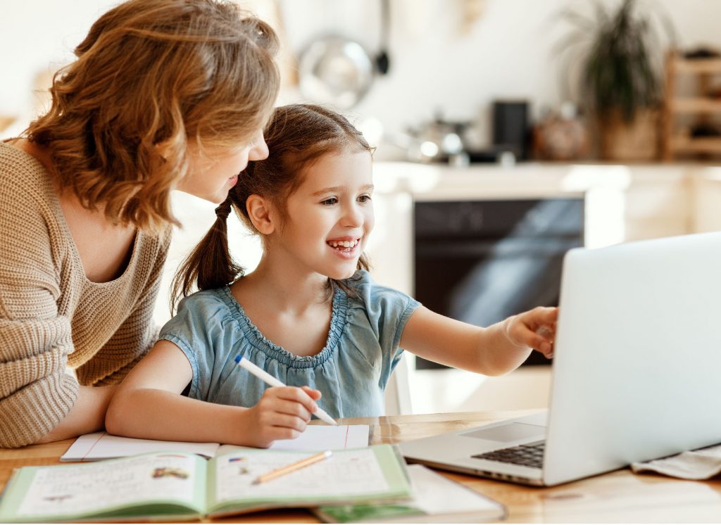 Photograph of mom and daughter looking at a computer
