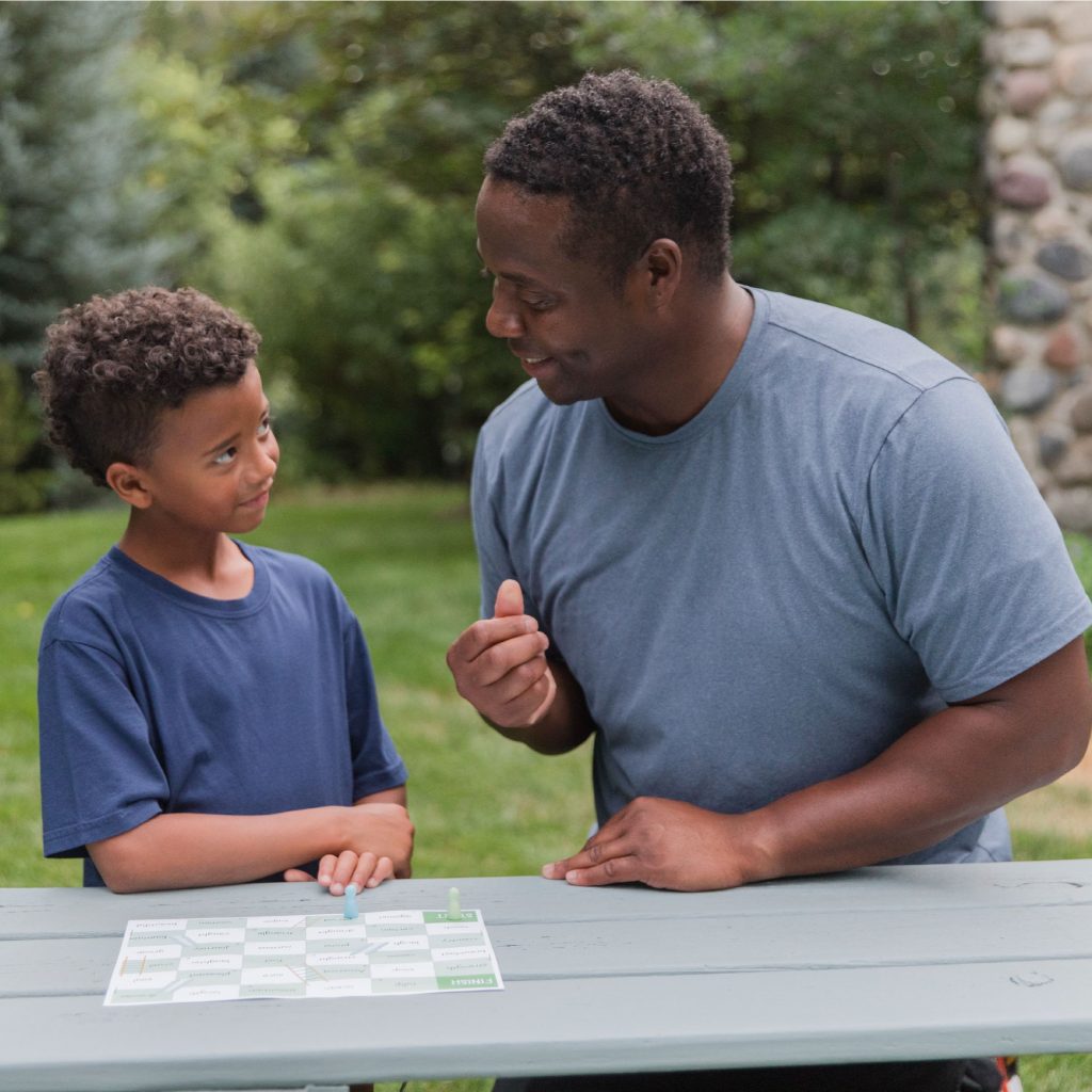 Photograph dad and son playing sight word games