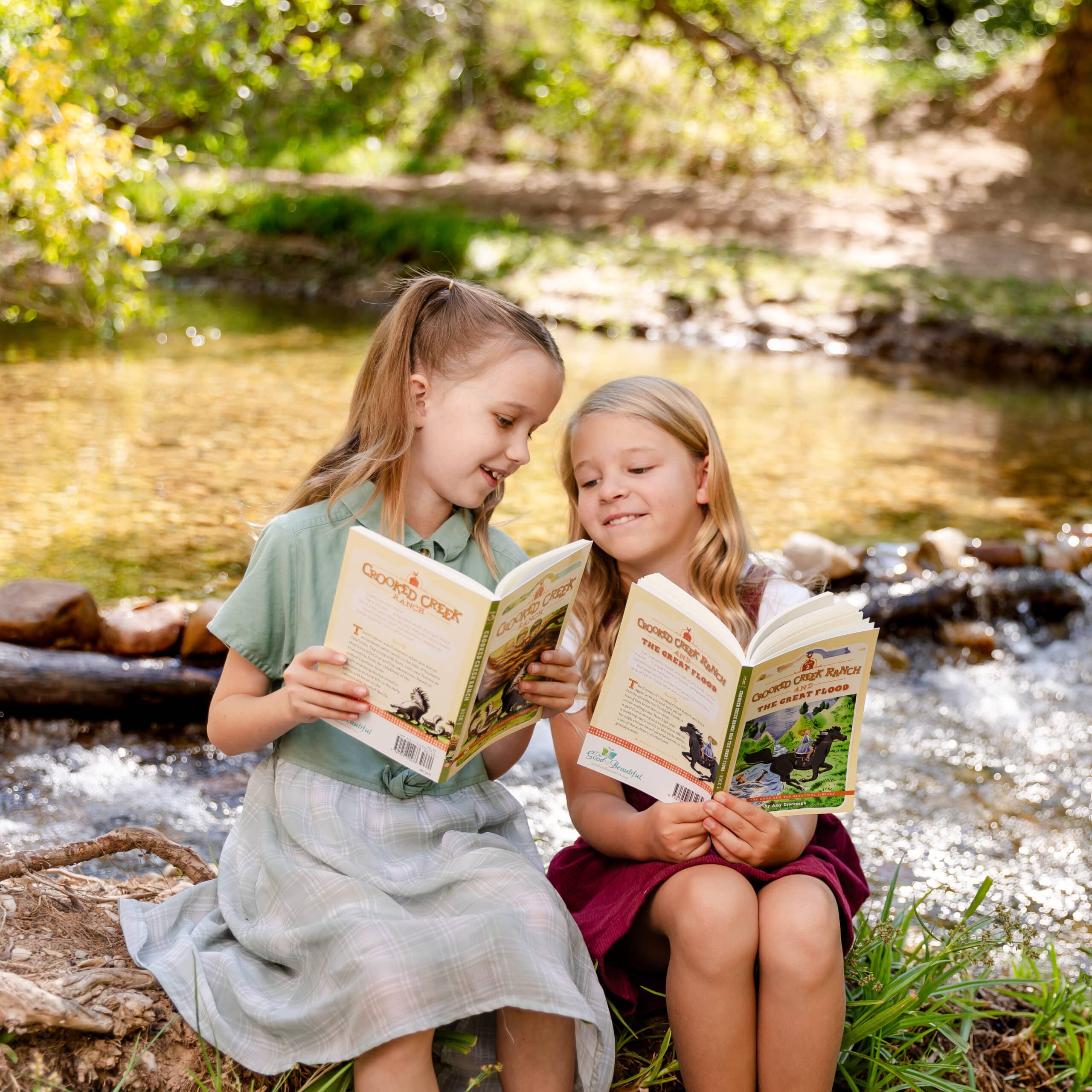 Photograph of Two Girls Reading Crooked Creek Ranch and the Great Flood Book