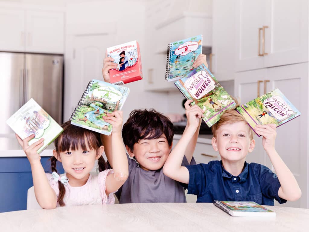 Photograph of 3 Children with Homeschool Reading Booster Cards and Books