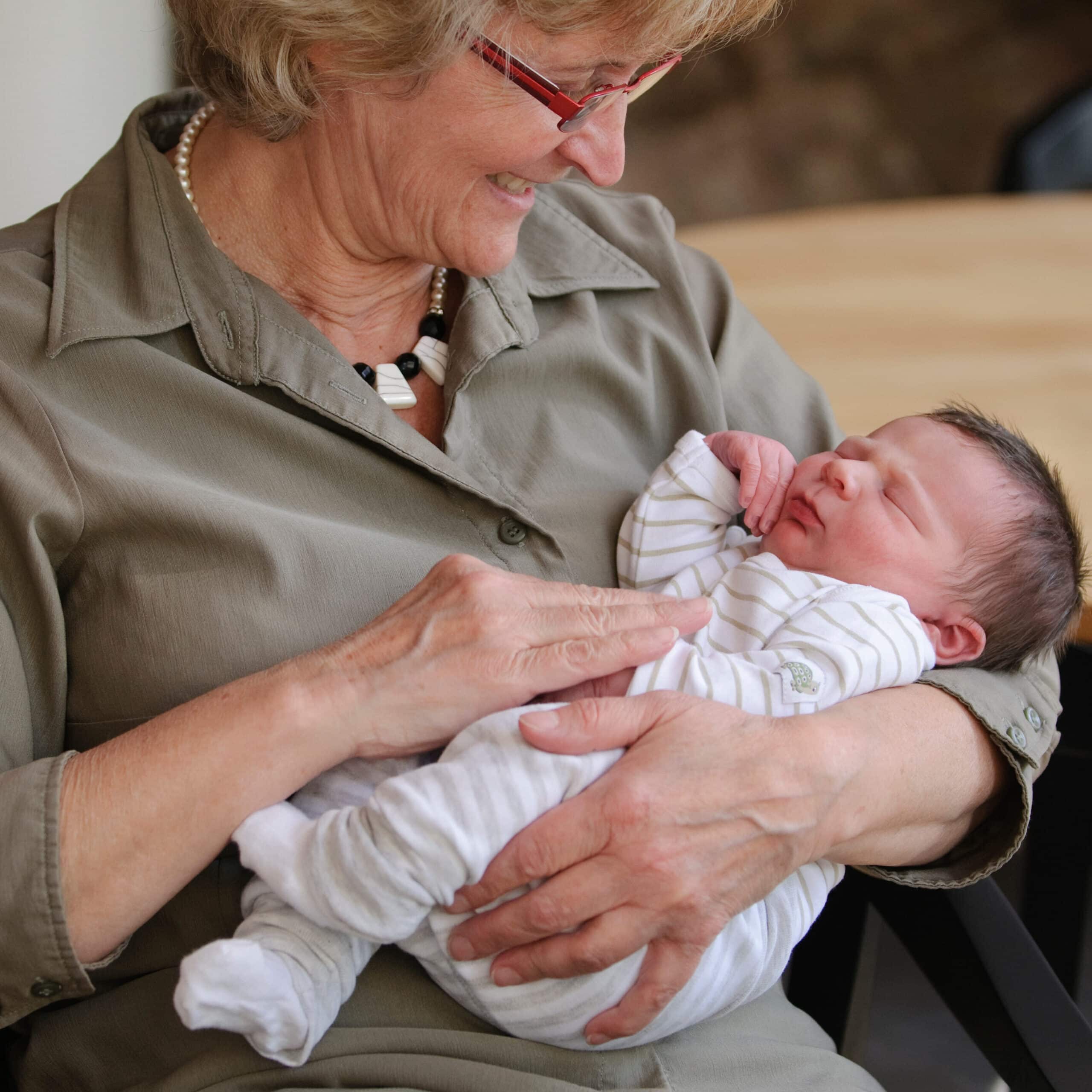 Photograph of Happy Grandma with Newborn Baby